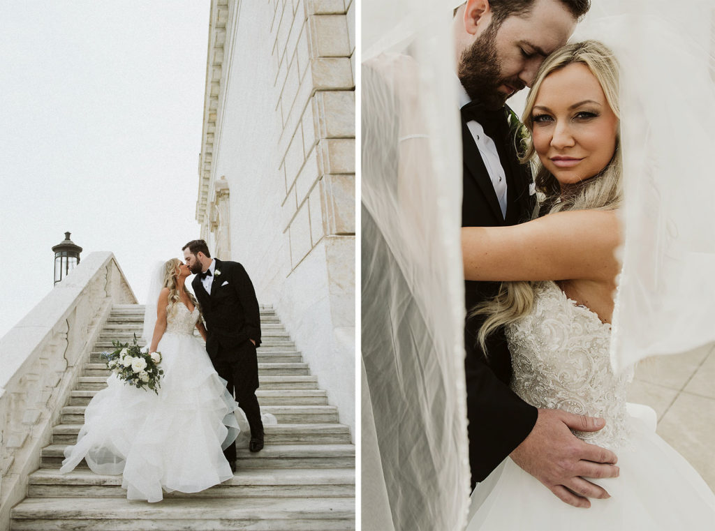 Bride and groom kiss on white stone stairs