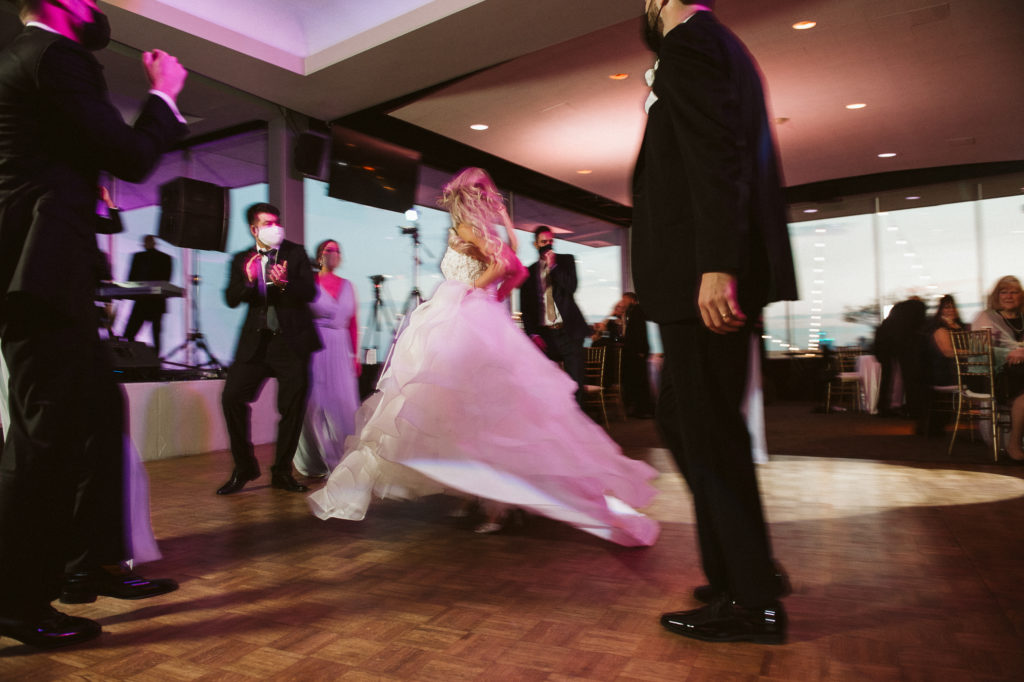 Bride laughing and twirling while dancing
